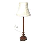 An Edwardian carved mahogany standard lamp with ribbed column on circular moulded base carved with