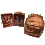 A Rexbilt cased portable tantalus containing two heavy cut decanters, glasses, etc; and a leather