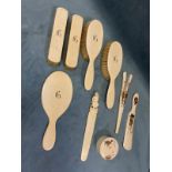 Miscellaneous pre-47 ivory including a five-piece Victorian dressing table set, a carved paperknife,