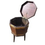 A Georgian mahogany wine cooler, the octagonal box having brass banding and ring handles with