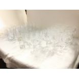 A quantity of drinking glasses mainly in sets - wine glasses, tumblers, brandy balloons, sherry,