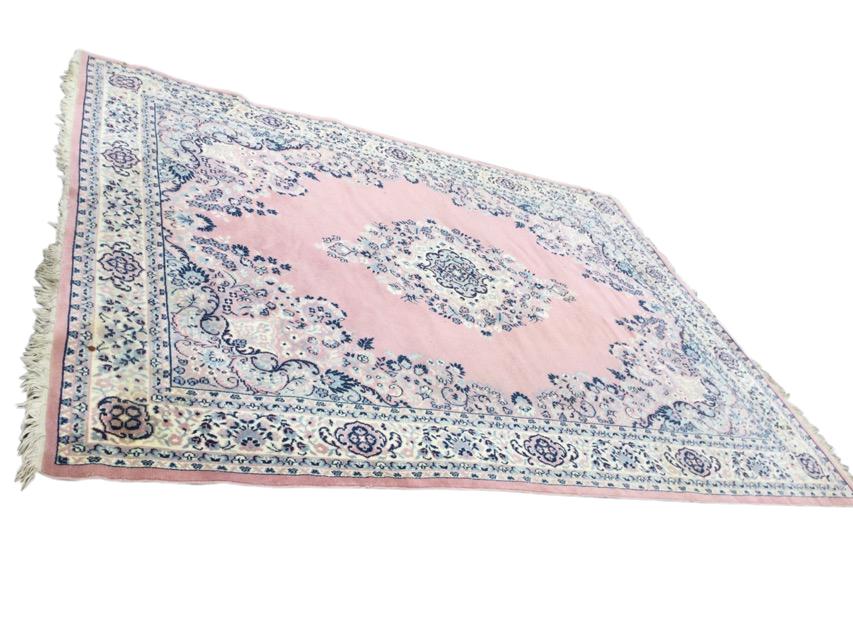 An Axminster style carpet woven with oval floral medallion and spandrels on pink field, framed by