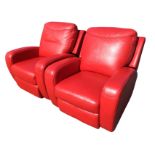 A pair of leather reclining deco shaped upholstered armchairs, with padded backs and sprung seats,