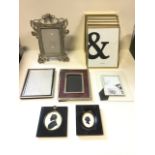 A pair of nineteenth century oval framed silhouettes; and a quantity of modern photo frames