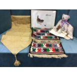 A bagged limited edition Steiff bear; an embroidered linen table runner; a brightly woven kelim; and