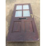 A hardwood front door with four double glazed panels above two fielded panels, the door fitted