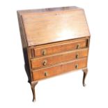 A mahogany bureau with moulded fallfront enclosing a fitted interior with pigeonholes and small