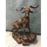 Moignier, bronze, study of a mountain goat perched on rocks holding sprig in mouth, signed. (14in)
