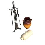 A set of wrought iron firetools on stand - poker, shovel, tongs; an ovoid German pot with scrolled