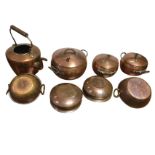 A set of three copper cooking pots with twisted wrought iron handles; a Victorian copper kettle; and