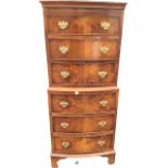 A bowfronted dwarf mahogany tallboy, the six drawers mounted with brass handles, raised on bracket