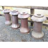 A set of four salt glazed stoneware bollard type chimney pots, with mushroom shaped rims on