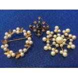 An Edwardian quatrefoil shaped brooch centered by sapphire on knife-edge bars set with seed pearls
