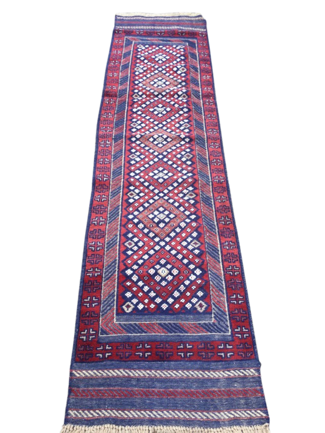 A rectangular Bokhara runner woven with diamond panel framed by chevron band, the outer border