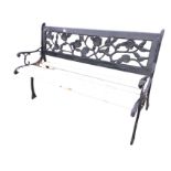 A rectangular garden bench, the back panel cast with pierced flowerheads and foliage in wood