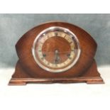 A domed oak cased CWS mantleclock, with silvered chapter ring under convex glass, raised on