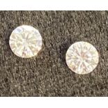 A pair of round brilliant cut diamonds, approx 0.25 carats each.