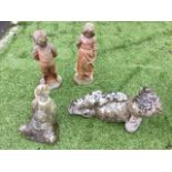 A composition stone girl & boy on circular plinths; a reclining composition stone teddy bear; and