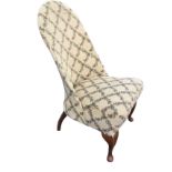 A spoonback nursing chair with sprung seat on cabriole legs.