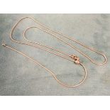 A rose gold plated necklace with lobster clasp, the sliding sphere adjusting the length of the loop,