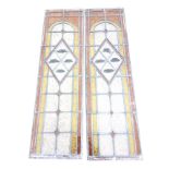 A pair of leaded rectangular stained glass panels, the central lozenge sections decorated with
