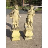 A pair of composition stone garden statues with young girl & boy on plinths, supported on bulbous