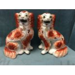 A pair of Victorian Staffordshire flatback wally dogs painted in brick red with yellow eyes and gilt