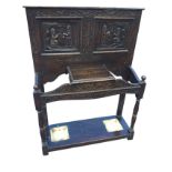 A carved oak hallstand, the back with a pair of carved medieval style figural panels depicting