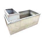 A rectangular 3ft galvanised trough with tubular rim, the end mounted with chamber for water