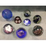 A collection of eight glass paperweights - a globe on stand, dragonfly ruby etched, Mdina,