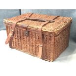 A Victorian cane picnic hamper with leather straps containing various tins, a tea kettle and an