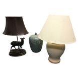 A resin bronze tablelamp modelled as a stag standing on naturalistic ground with leather shade; a
