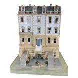 A large dolls house constructed as a 1/12th scale regency town house, the stuccoed building