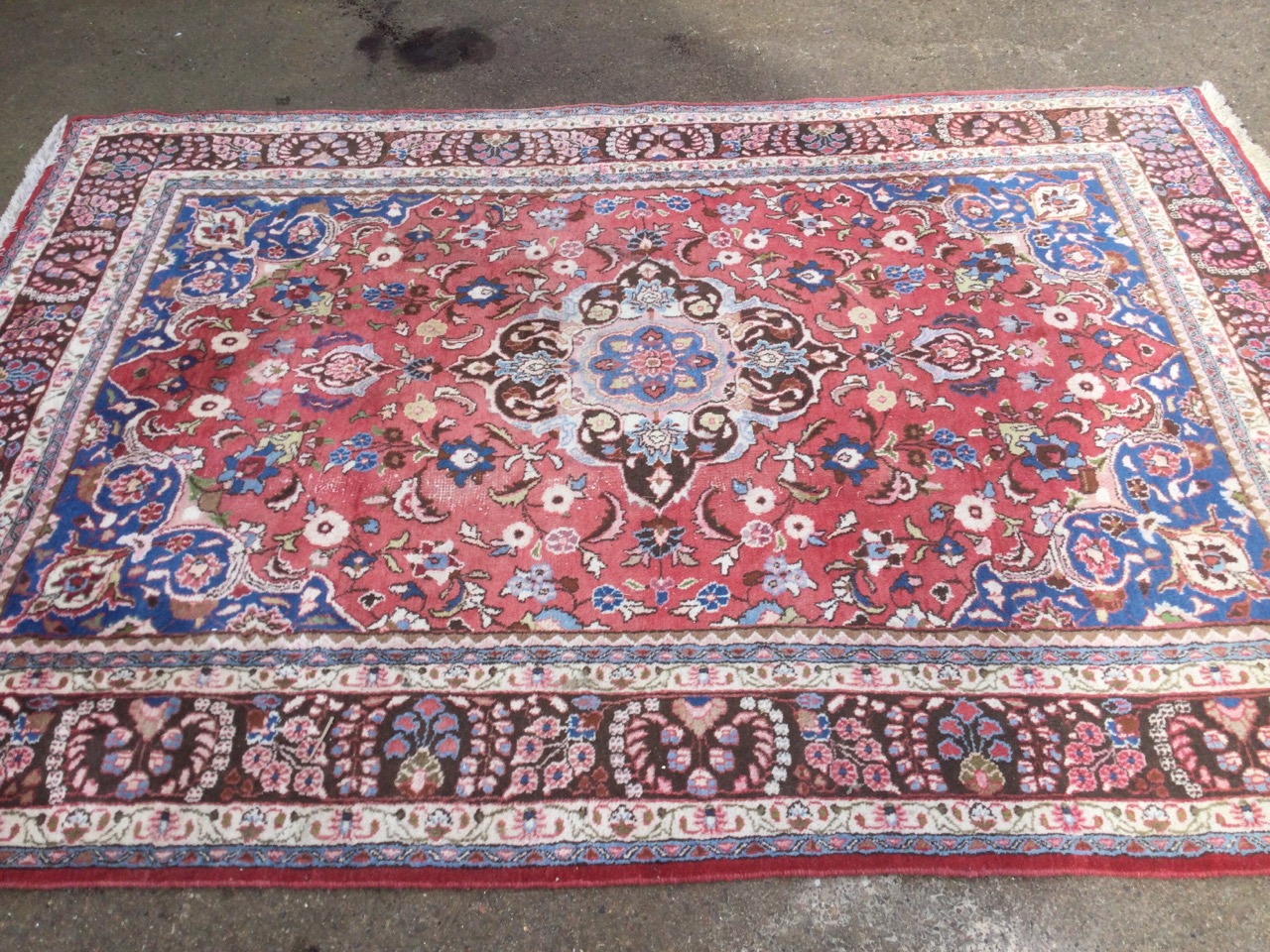 A large Indian rug woven with pink floral field having blue spandrels, framed by brown frieze of - Image 2 of 3