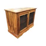 A hardwood cabinet with rectangular top above iron mesh panelled doors, supported on a shaped apron.