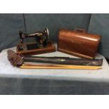 A C20th Singer sewing machine in domed oak case with swing handle; and a cased Elf two-piece snooker