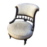 A Victorian ebonised and ormolu mounted saloon chair, with upholstered padded back on channelled