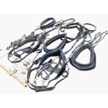 A quantity of horse carriage driving gear including collars, girths, bridles, pairs, swingers,