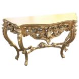 A reproduction serpentine fronted rococo style hall table with shaped top above a pierced scrolled