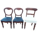 A pair of Victorian mahogany balloon back dining chairs with drop-in serpentine shaped seats