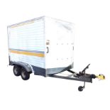 A four-wheel box trailer, the ribbed fibreglass body with drop-down back having locking hitch,