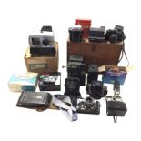 A boxed lantern projector; a 60s boxed Gnome slide projector; and a collection of cameras and