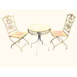 A circular metal garden table with two chairs, the table with pierced scrolled apron on four