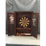 A mahogany cased dartboard, the cabinet with moulded cornice and panelled doors with blackboard