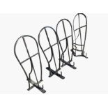 A set of three wall mounting saddle racks with hooped supports having hooks bellow; and another
