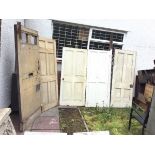 Five miscellaneous old painted doors - four panelled Victorian, a thick old eight panelled front