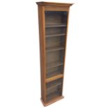 A tall glazed oak cabinet with moulded cornice above two glass doors enclosing adjustable shelves,
