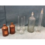 A pair of stoneware salt glazed ink jars; three long necked chemists flasks; a tubular stoppered