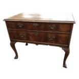 A nineteenth century walnut lowboy, the quarter veneered crossbanded top under plate glass, having