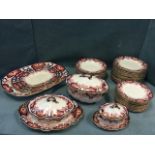 A Royal Crown Derby dinner service in the traditional brick-red, blue and gilt scrolled floral